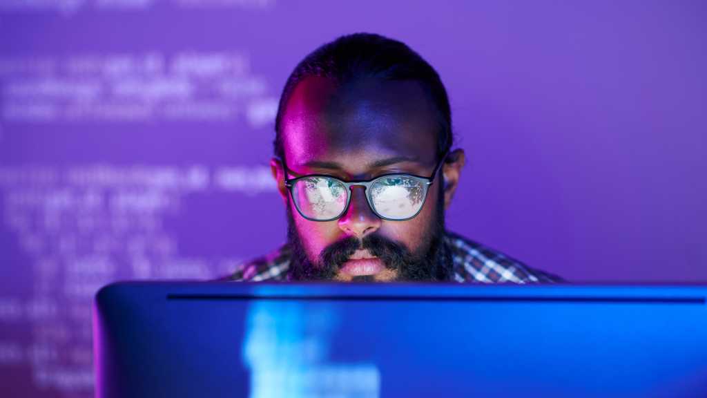 Developer coding in front of computer