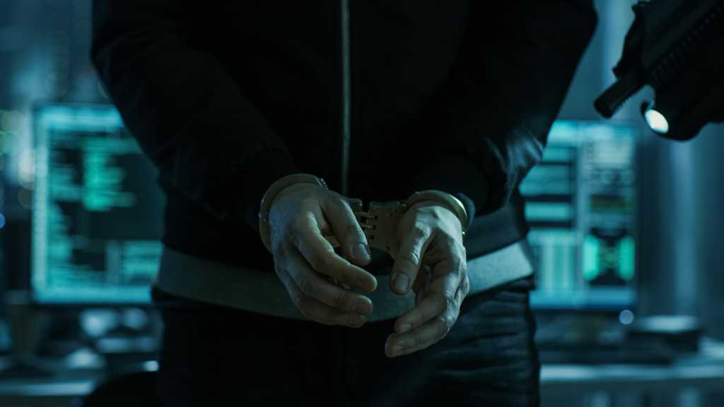 hacker in handcuffs ransomware