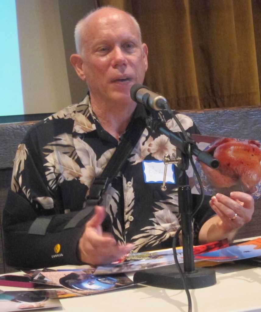 photo of Bill Atkinson sitting at table behind microphone